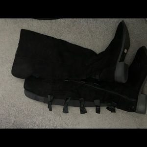 Over the knee black suede boots.